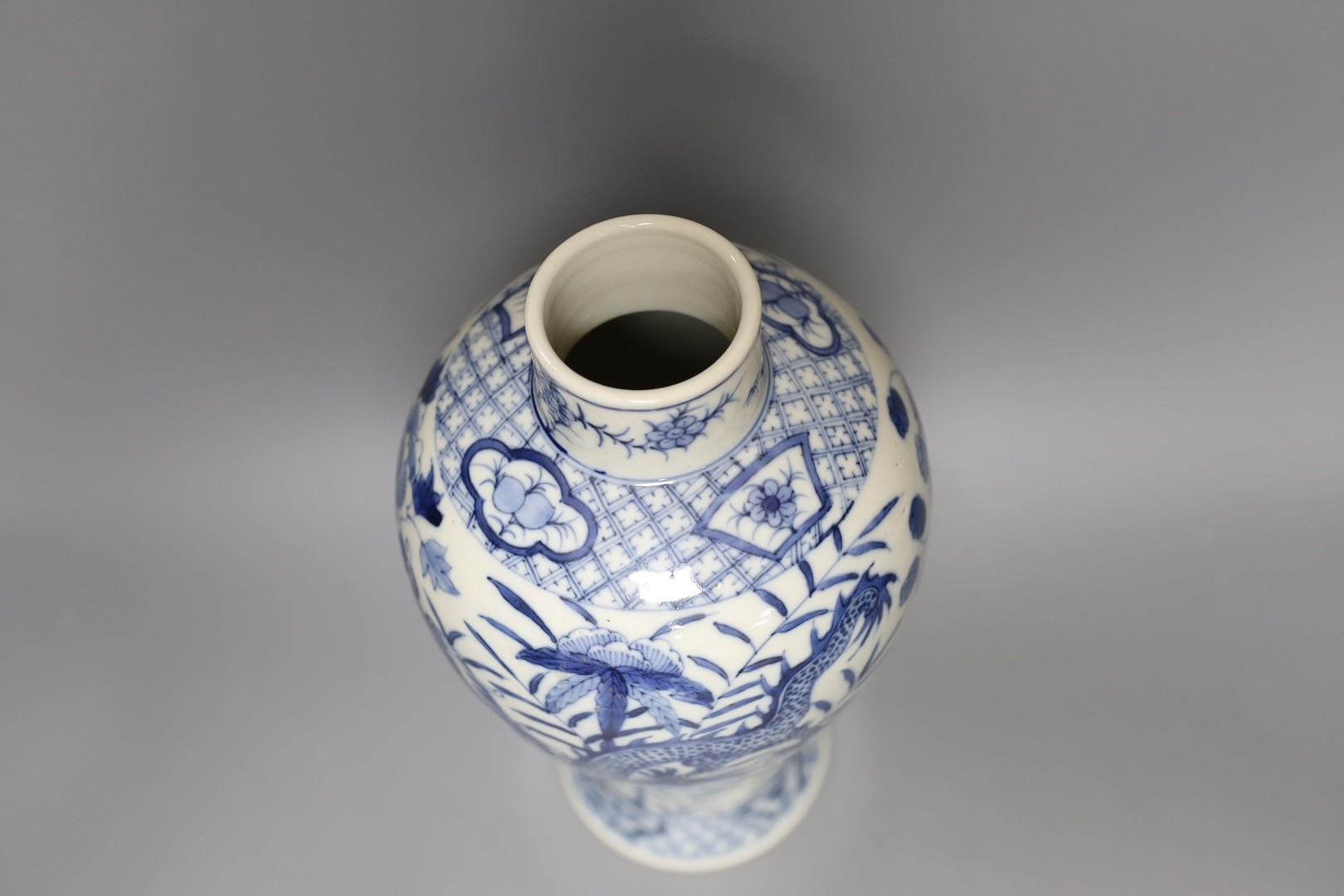 A Chinese blue and white ‘dragon’ vase. Kangxi mark but later, 31cm